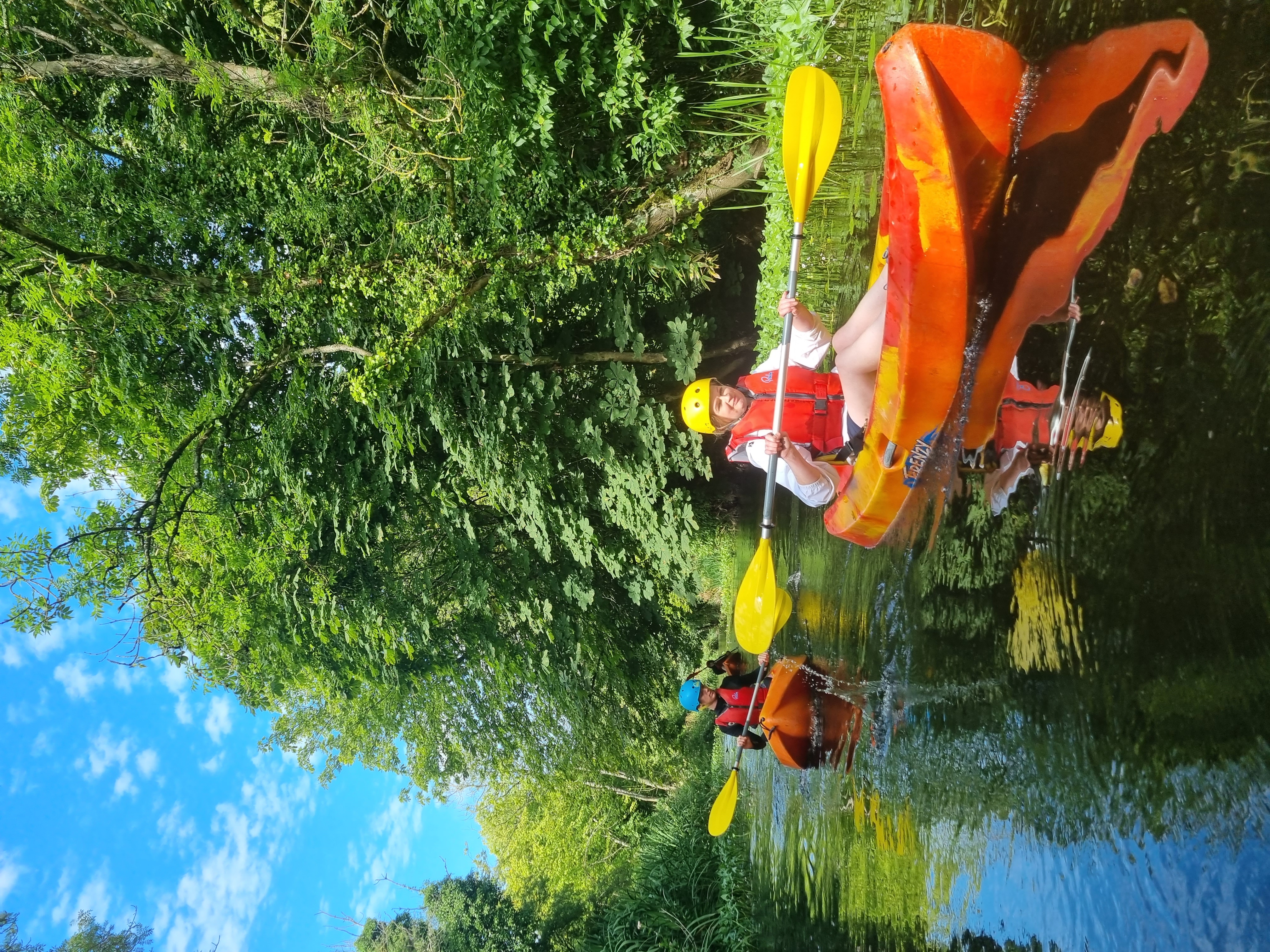 Kayakers launching from the shore on a sunny day on the River Boyne